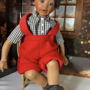 Marcus, a 20-inch porcelain and cloth doll with vintage charm and poseable limbs.